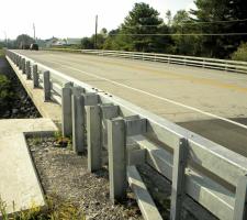 Completed bridge with curbless deck rail