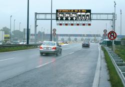 car on road with graphic sign