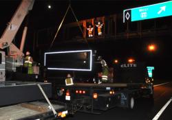 Crane lifting new sign