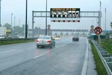 car on road with graphic sign