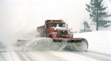 Snow plough clearing snow off the road 